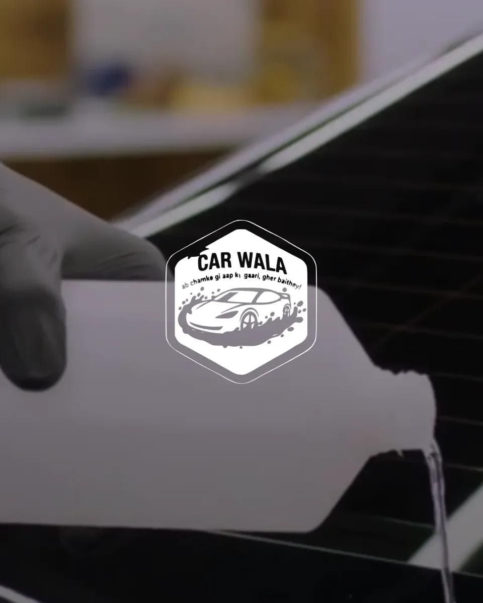 Car Wala, the badge over a detailer pouring foam on a black bonnet