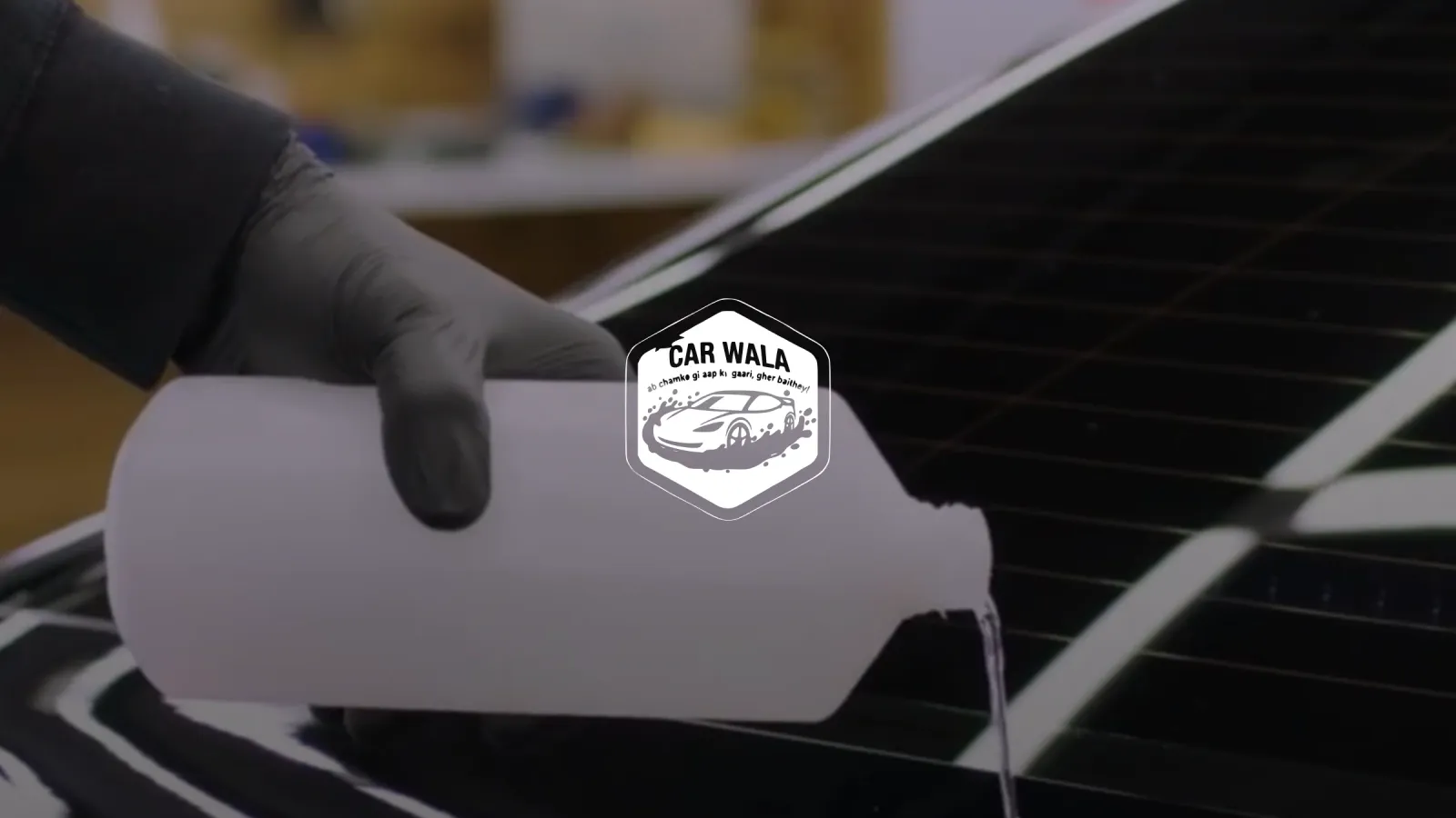 Car Wala, the badge over a detailer pouring foam on a black bonnet